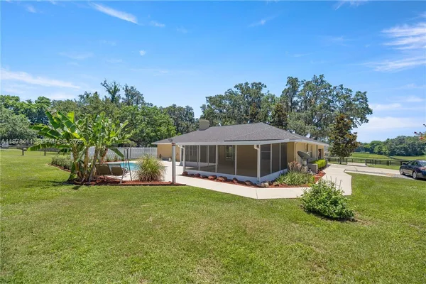 a view of a house with a yard porch and sitting area