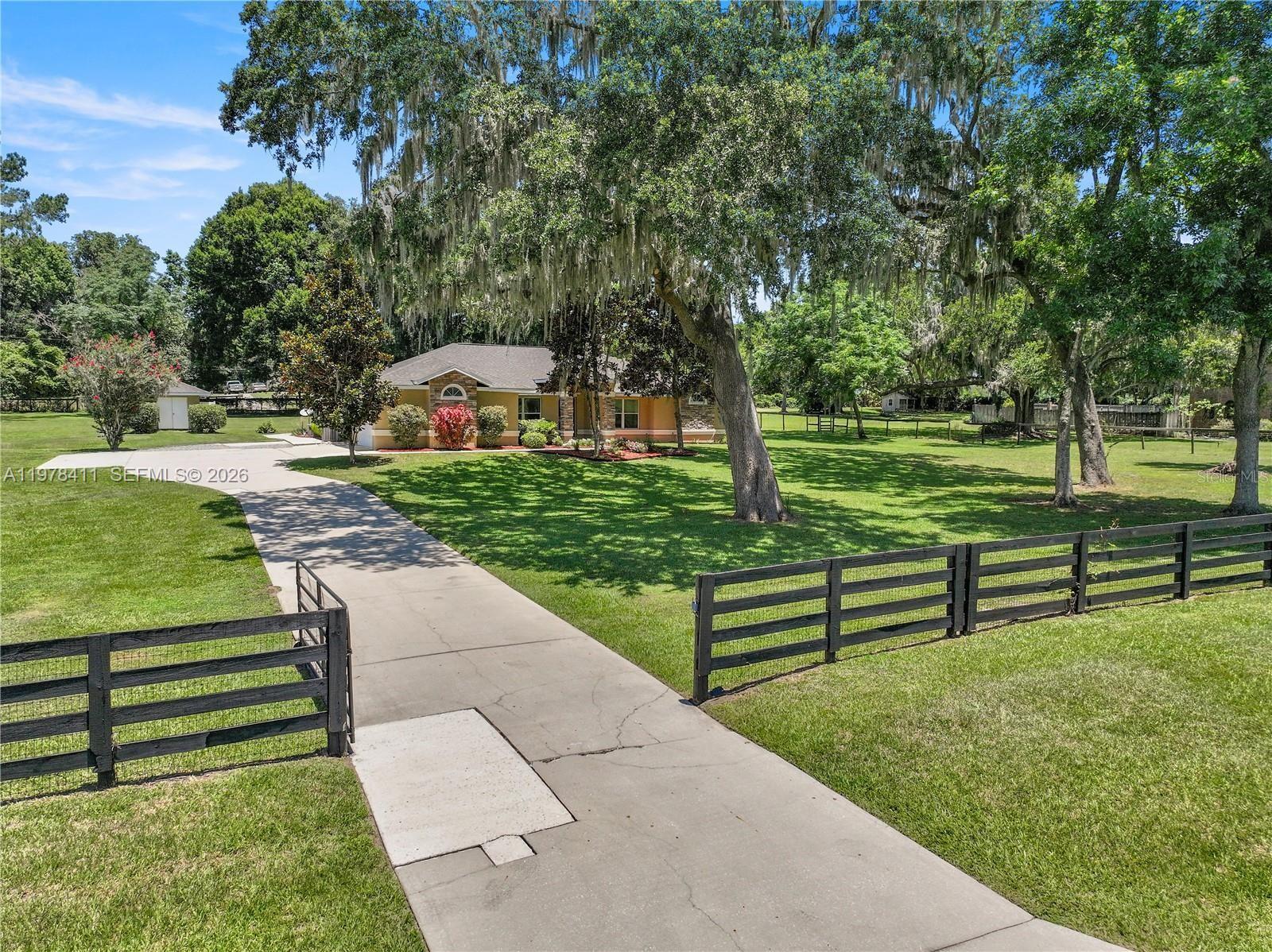 1699 Southwest 80th Street Ocala, FL 34476 - Photo 8 of 47 a front view of a house with a yard