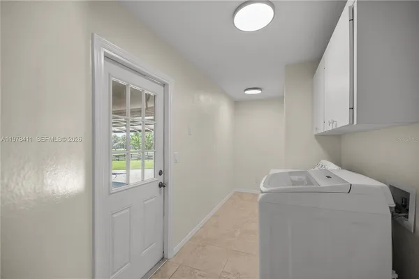a utility room with closet dryer and washer