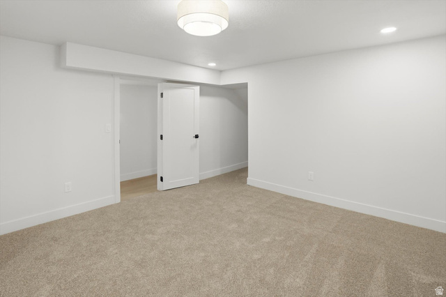 8760 Rustler Road Cottonwood Heights, UT 84093 - Photo 41 of 57 Spacious room with new neutral carpeting, crisp white walls, and a contemporary flush mount light fixture