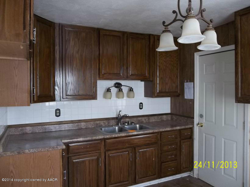 4604 Cline Road Amarillo, TX 79110 - Photo 2 of 7 a kitchen with a sink and cabinets