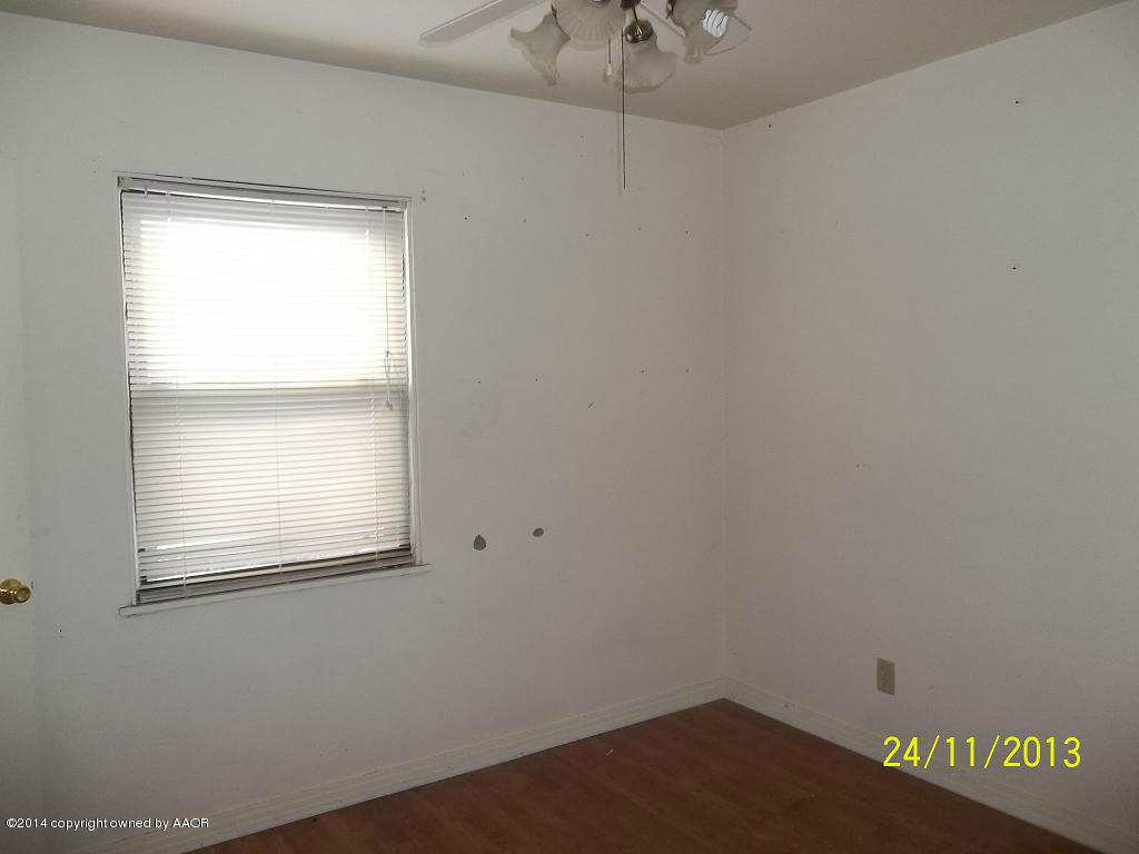 4604 Cline Road Amarillo, TX 79110 - Photo 4 of 7 an empty room with a window