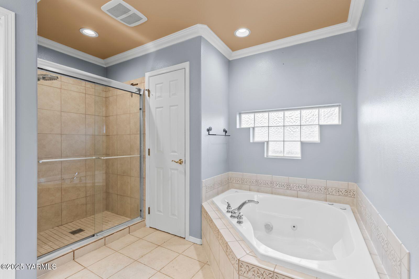 a bathroom with a bathtub and shower