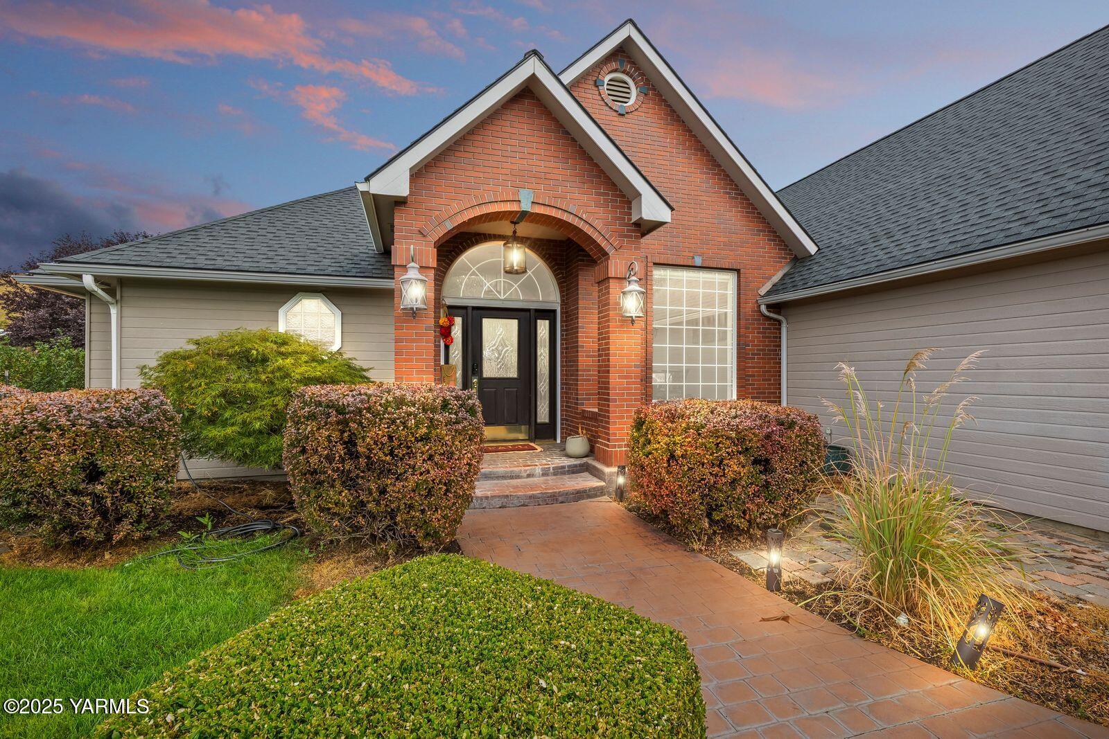 a front view of a house with garden