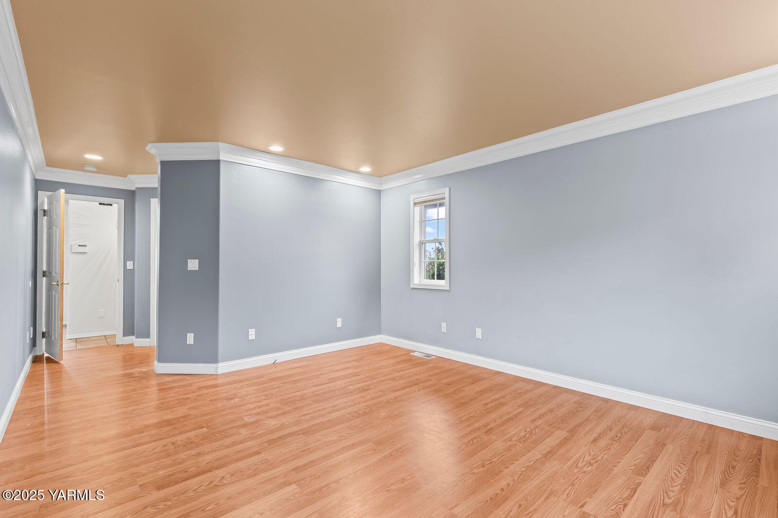 10709 Summitview Road Yakima, WA 98908 - Photo 18 of 32 a view of an empty room with wooden floor and a window