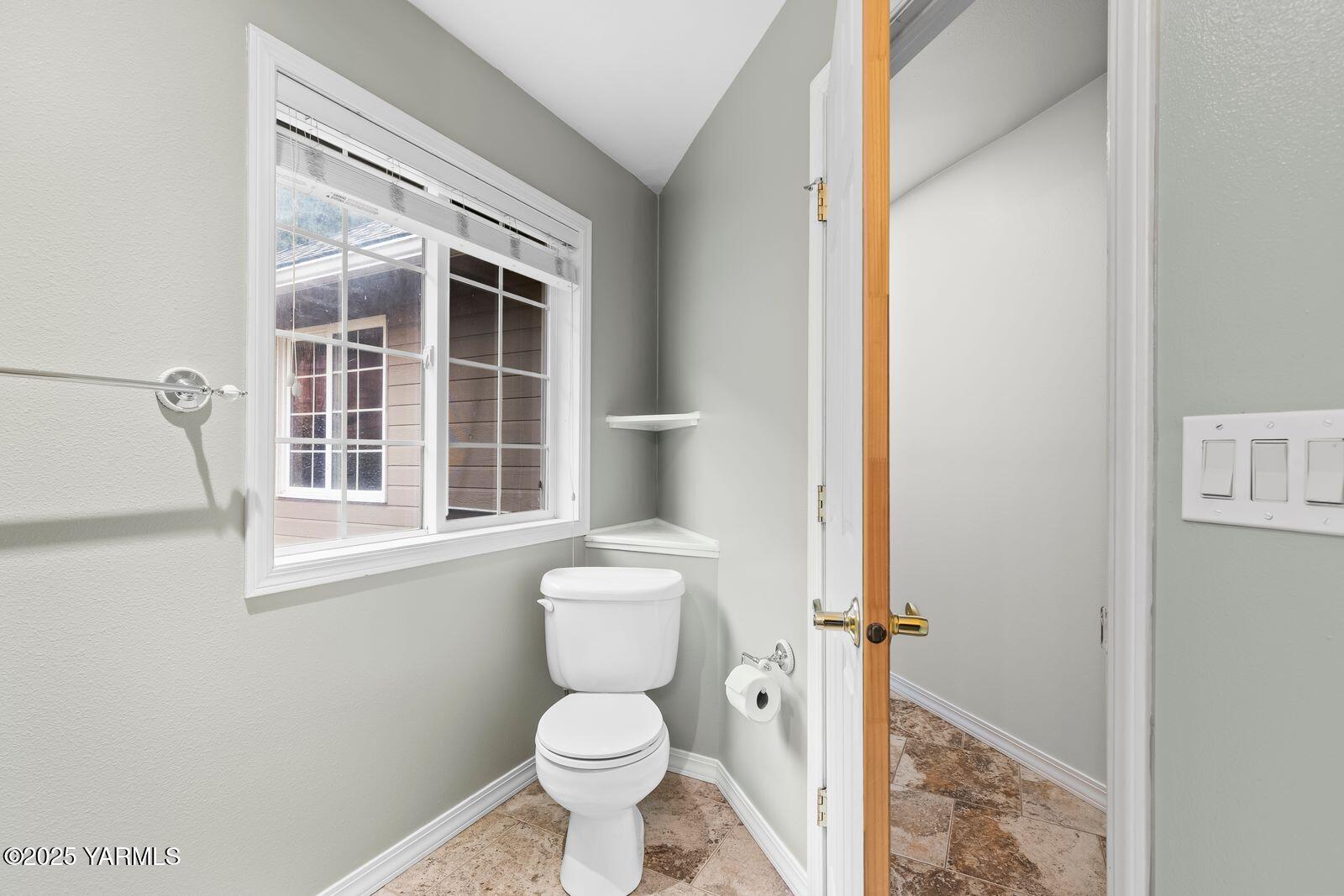 10709 Summitview Road Yakima, WA 98908 - Photo 25 of 32 a bathroom with a toilet and a window