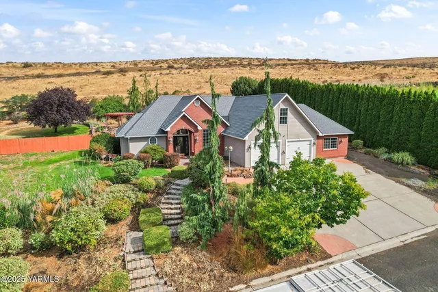 a view of a house with a yard and ocean view