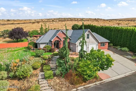 a view of a house with a yard and ocean view