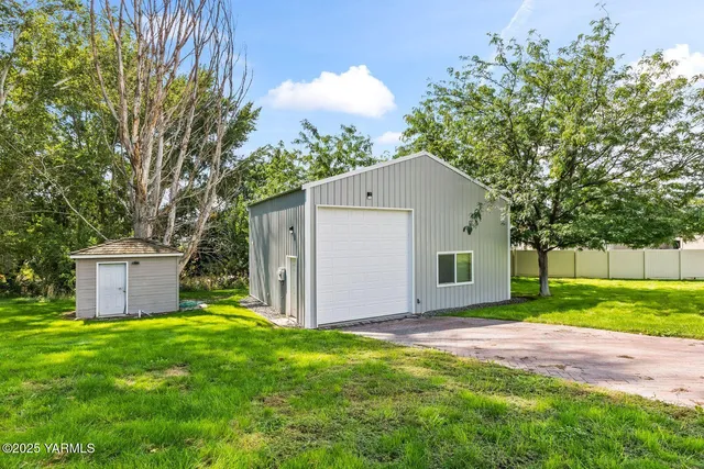 a front view of house with yard and trees