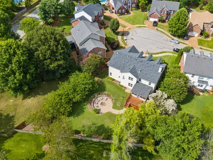 an aerial view of residential house with outdoor space and swimming pool