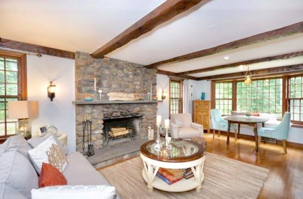 10 Wamsutta Road Scituate, MA 02066 - Photo 20 of 30 a living room with a fireplace dining table and a large window