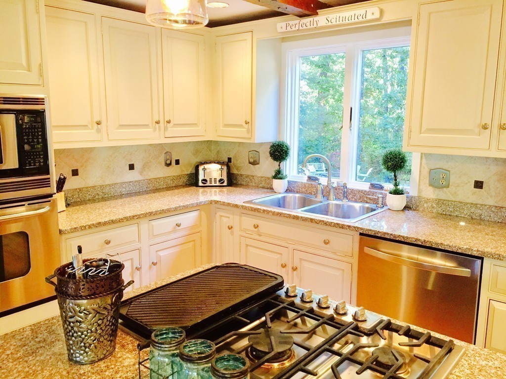 10 Wamsutta Road Scituate, MA 02066 - Photo 9 of 30 a kitchen with a sink and a stove next to a window