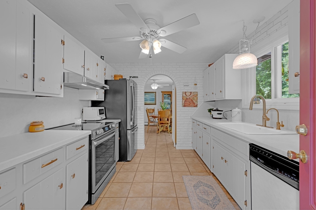 47 Horseshoe Circle Ware, MA 01082 - Photo 10 of 37 a large white kitchen with a stove a sink a refrigerator and cabinets