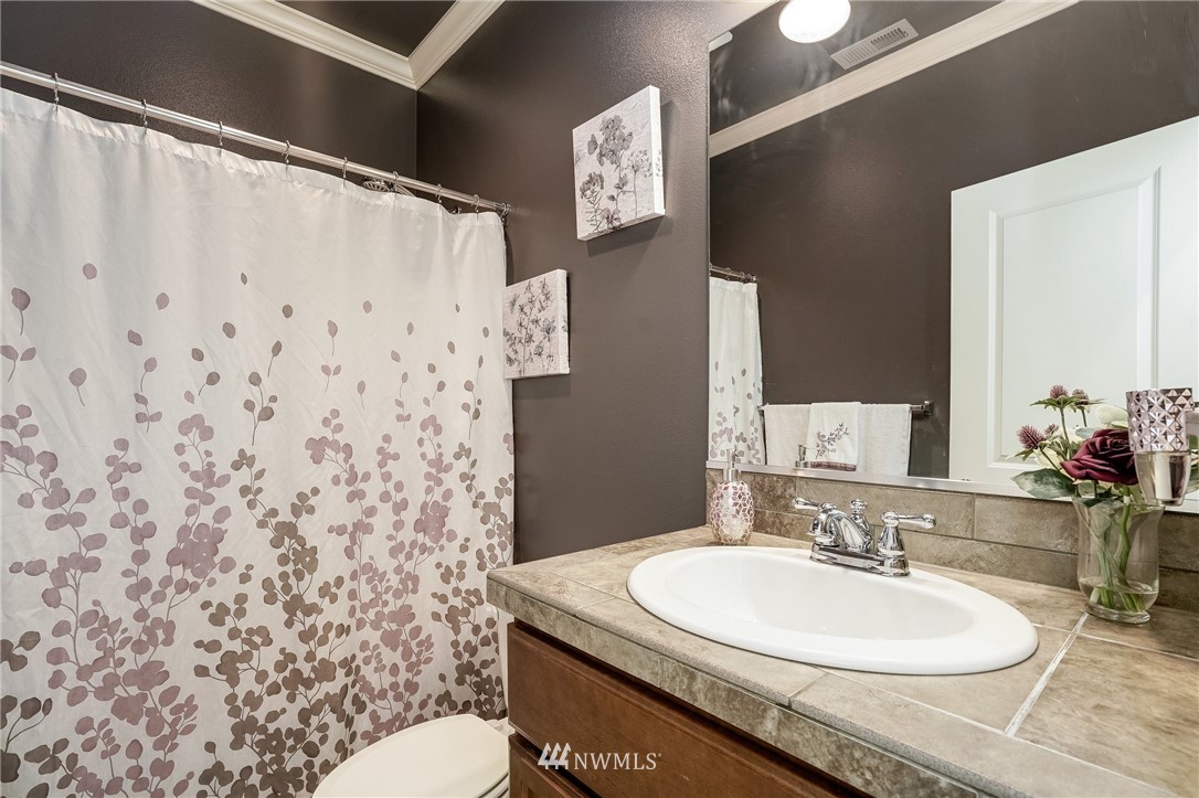 3408 223rd Place Southeast Bothell, WA 98021 - Photo 15 of 40 a bathroom with a granite countertop sink and a mirror