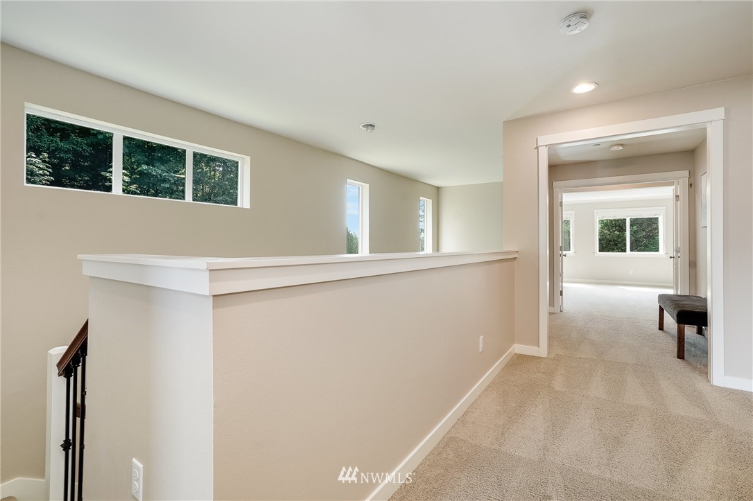 3408 223rd Place Southeast Bothell, WA 98021 - Photo 19 of 40 a view of a big room with wooden floor and windows
