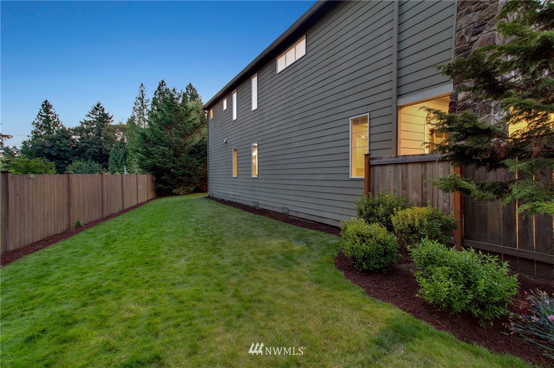 3408 223rd Place Southeast Bothell, WA 98021 - Photo 39 of 40 a view of a backyard with plants and large tree