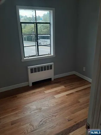 a view of a room with wooden floor and windows