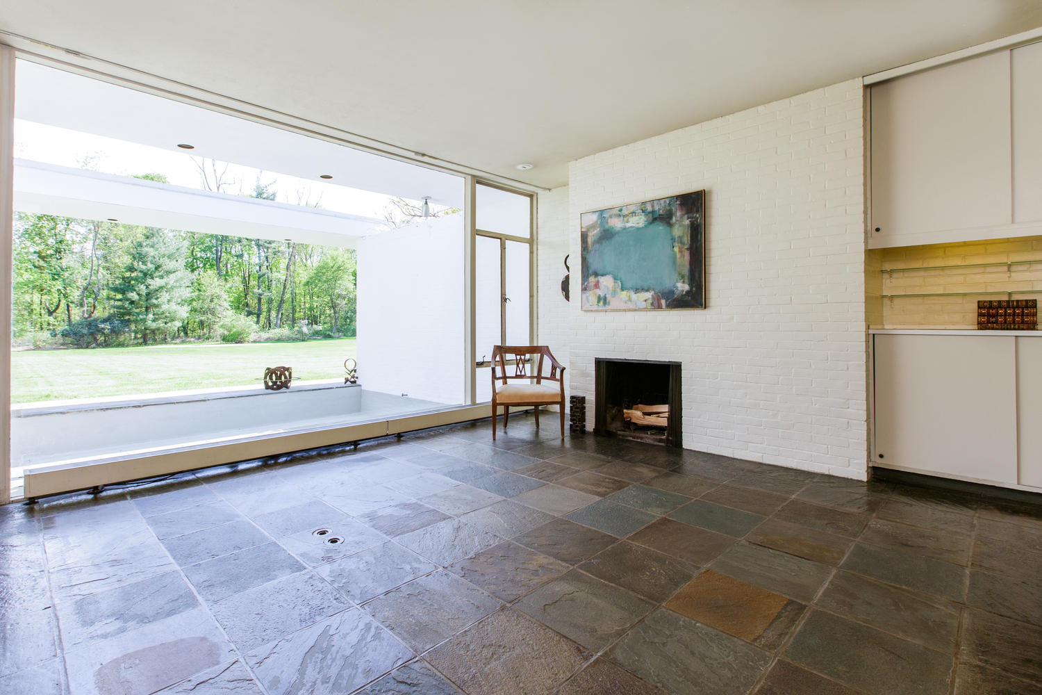 90 Lambert Road New Canaan, CT 06840 - Photo 11 of 28 a large living room with a fireplace and a large window