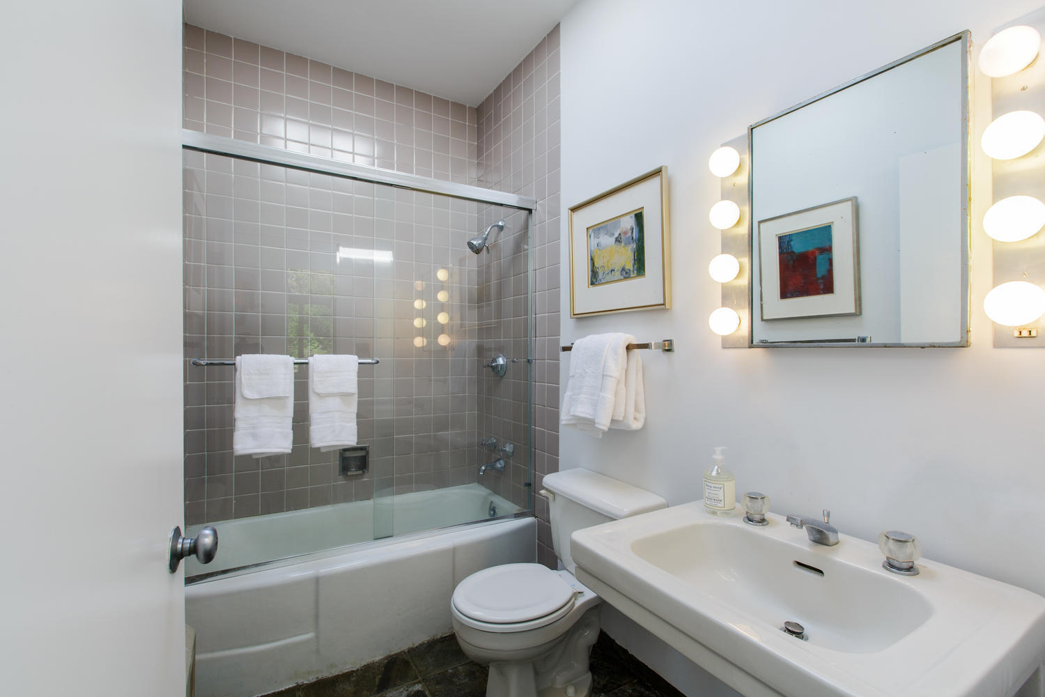 90 Lambert Road New Canaan, CT 06840 - Photo 16 of 28 a bathroom with a bathtub shower sink mirror vanity and toilet