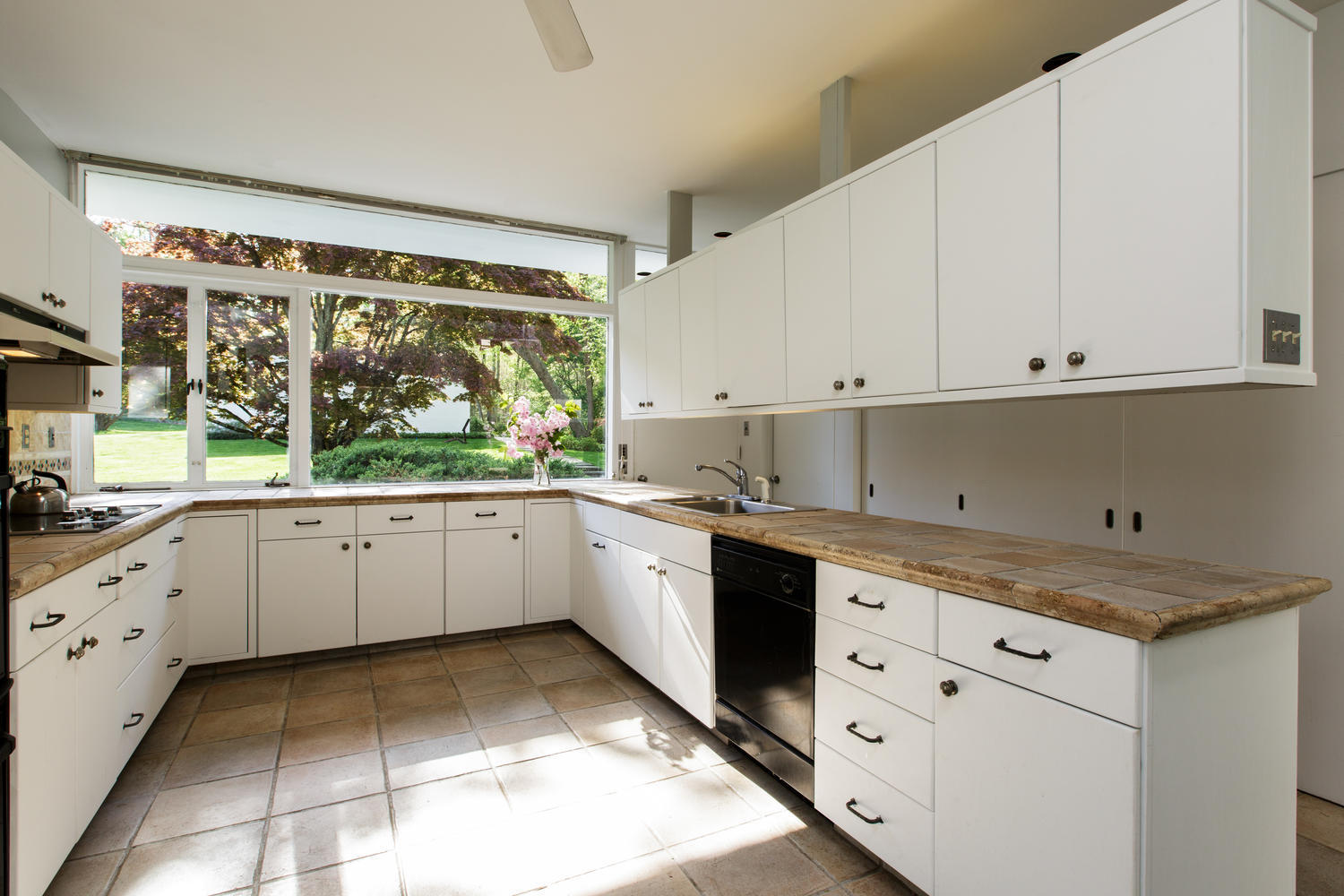 90 Lambert Road New Canaan, CT 06840 - Photo 19 of 28 a kitchen with granite countertop white cabinets and white appliances