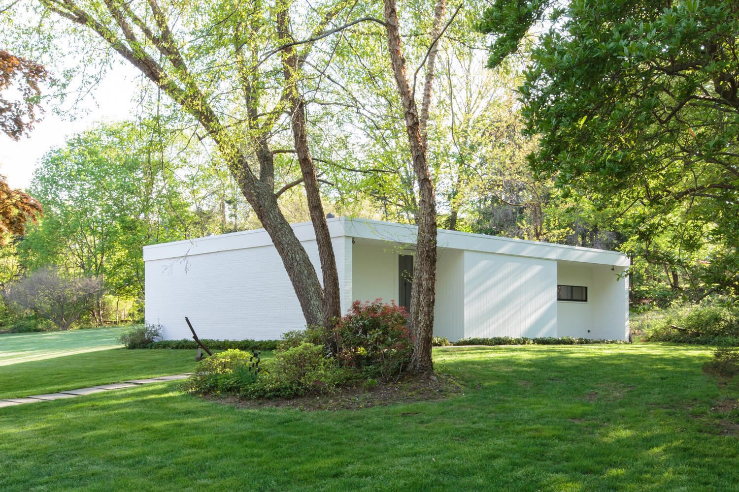 90 Lambert Road New Canaan, CT 06840 - Photo 21 of 28 a view of a backyard with potted plants and large trees