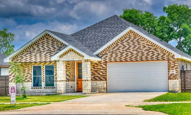 front view of a house with a yard