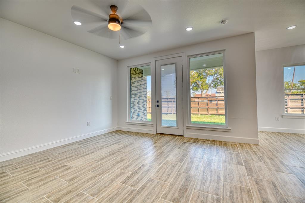 809 South Adelaide Street Terrell, TX 75160 - Photo 22 of 38 an empty room with wooden floor and windows