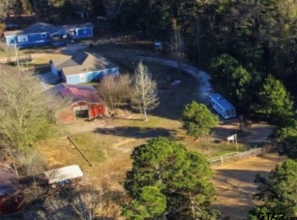 a view of swimming pool with lawn chairs and plants