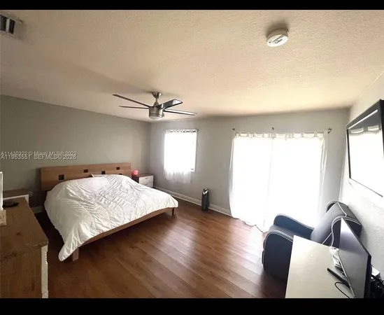 a bedroom with a bed and a couch