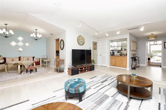 a kitchen with stainless steel appliances granite countertop a refrigerator a sink a stove and a microwave