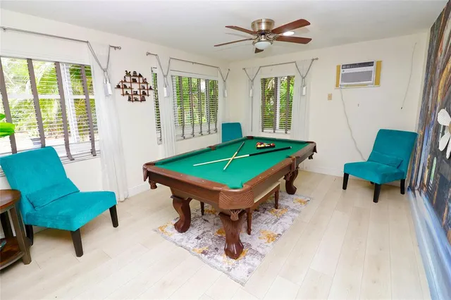 a bedroom with a bed and painting on the wall