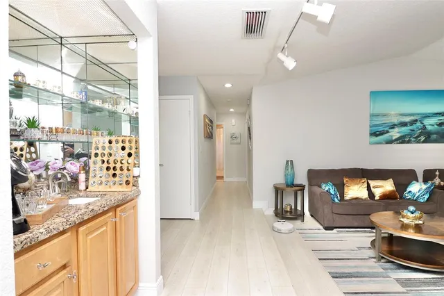 a living room filled with furniture hardwood floor and a floor to ceiling window