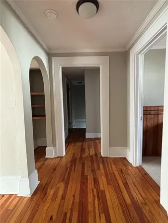 a view of a room with wooden floor