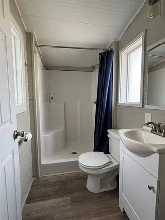 a bathroom with a sink toilet and shower