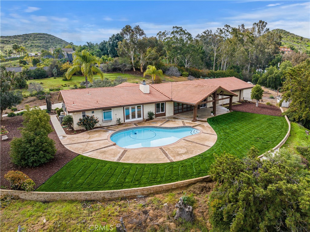 an aerial view of residential houses with outdoor space and pool