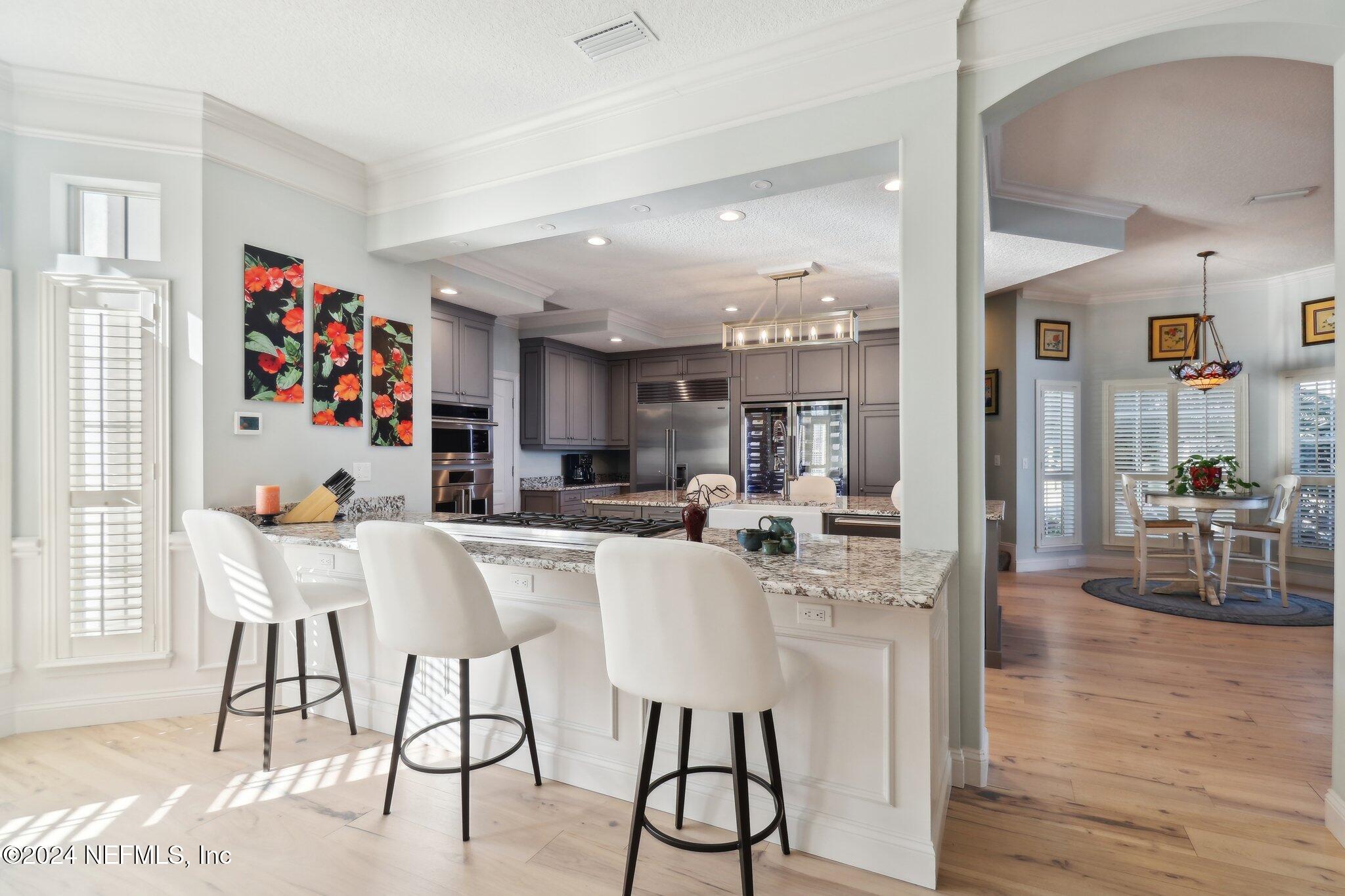 240 Pinehurst Pointe Drive St. Augustine, FL 32092 - Photo 16 of 70 a view of a dining room with furniture and wooden floor