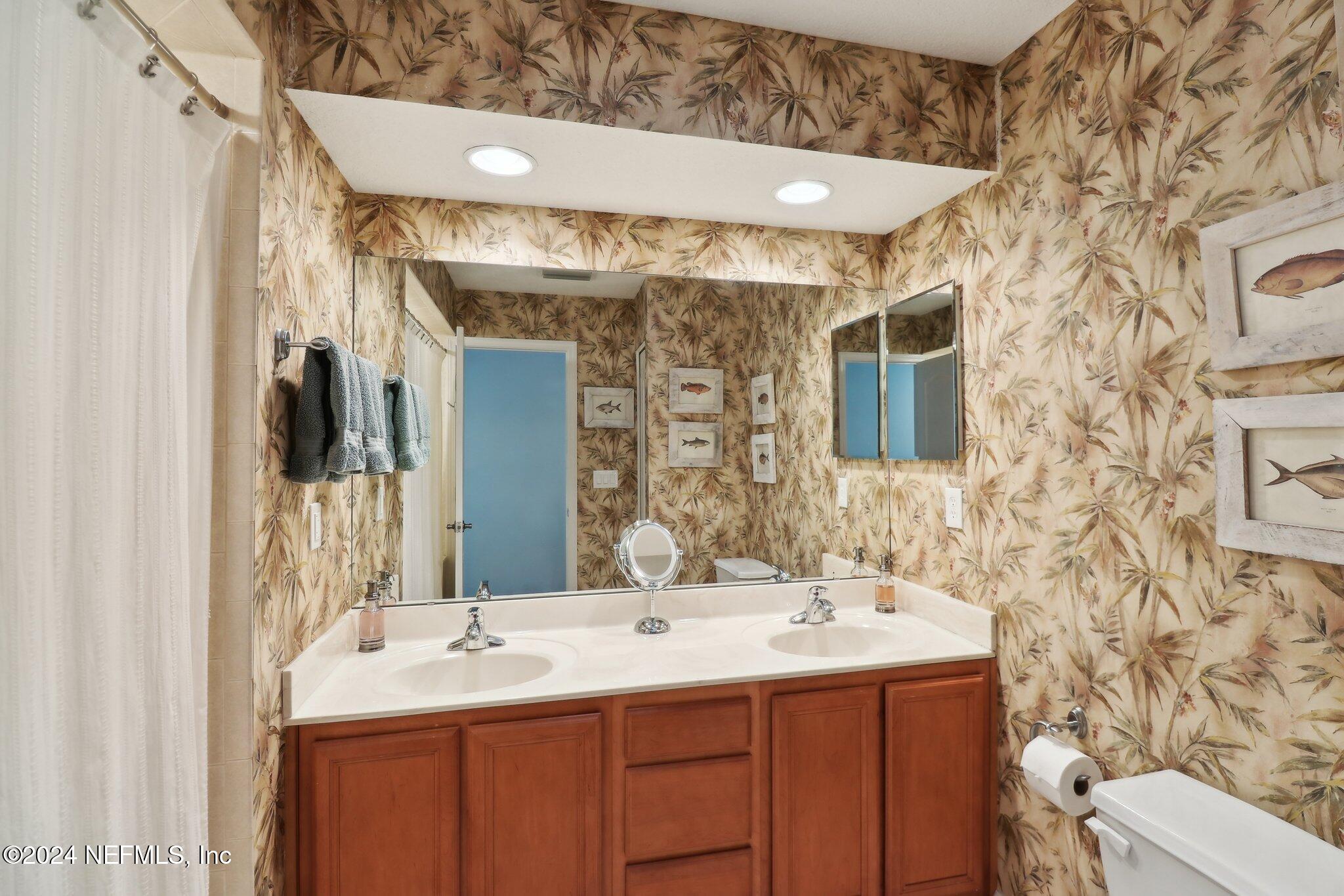 240 Pinehurst Pointe Drive St. Augustine, FL 32092 - Photo 36 of 70 a bathroom with a sink and a mirror