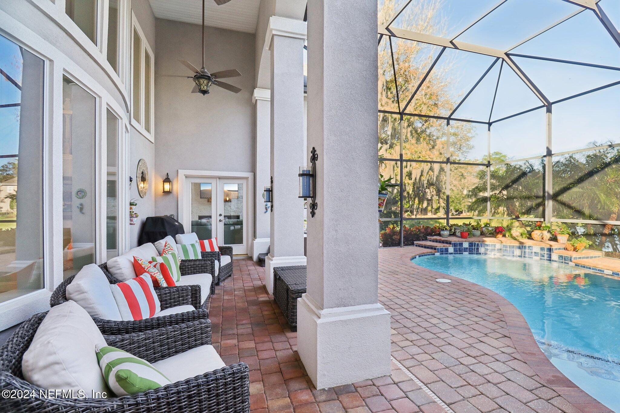 240 Pinehurst Pointe Drive St. Augustine, FL 32092 - Photo 43 of 70 a living room with furniture and a floor to ceiling window