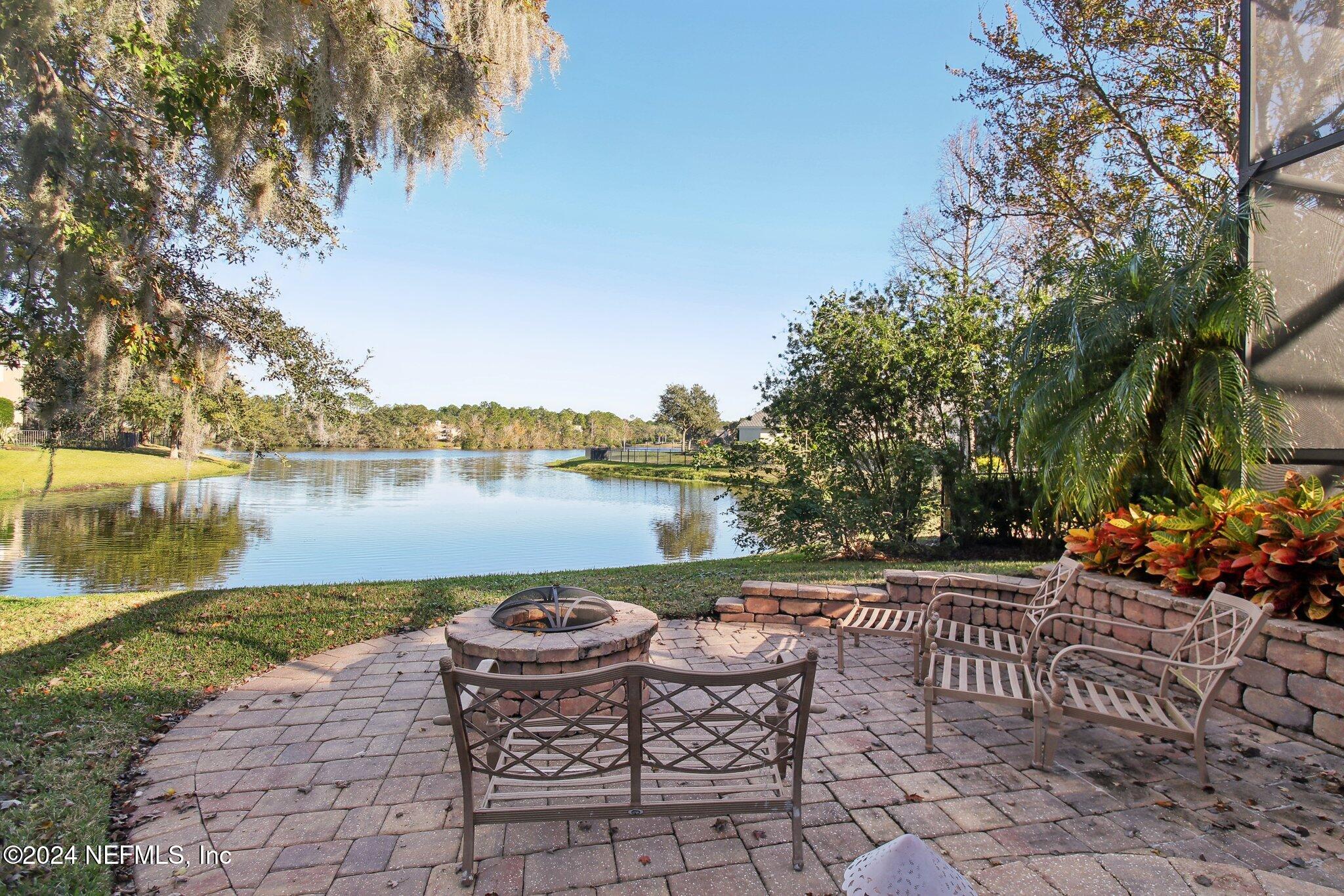 240 Pinehurst Pointe Drive St. Augustine, FL 32092 - Photo 49 of 70 a view of a lake with table and chairs