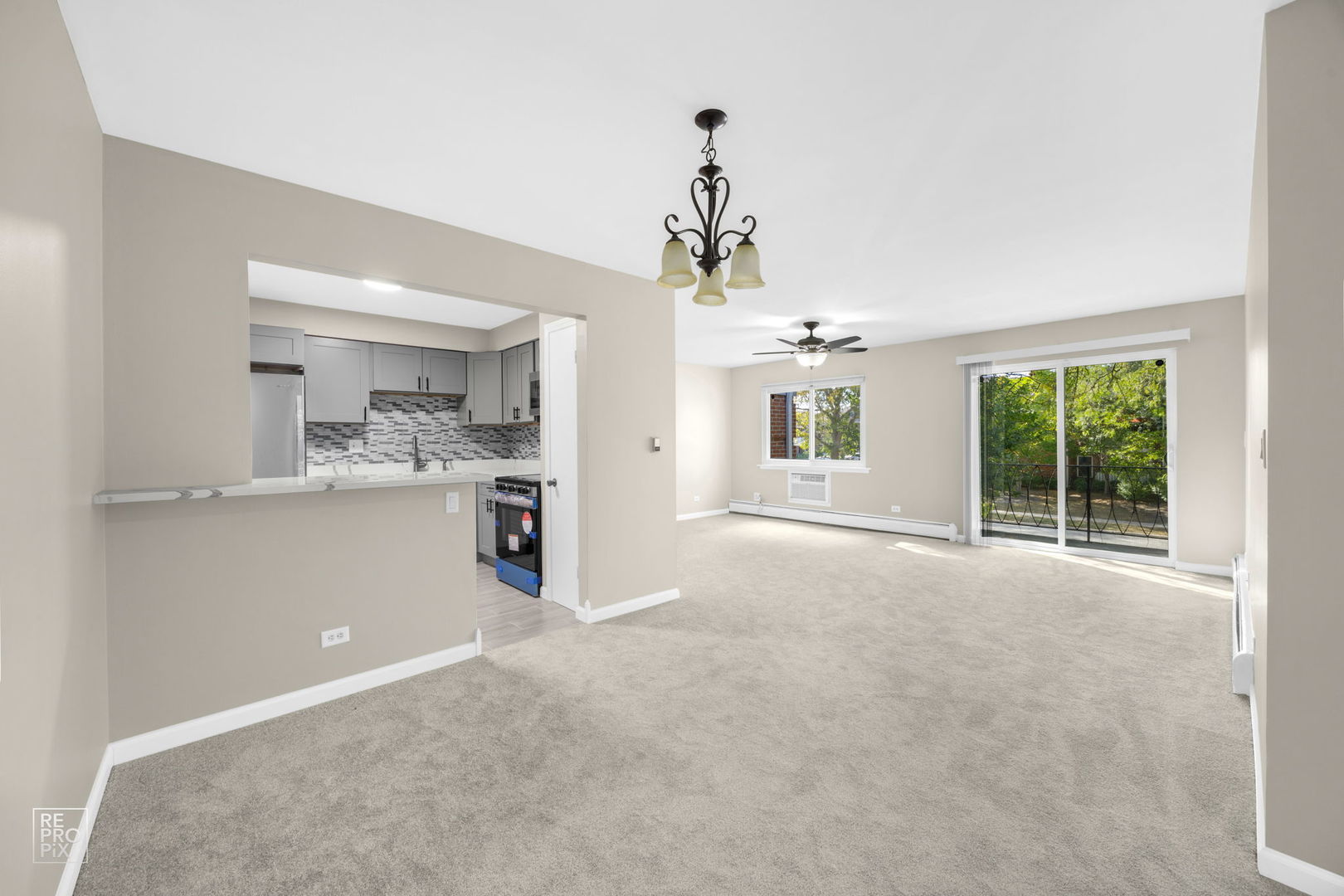 2303 South Goebbert Road, Unit A207 Arlington Heights, IL 60005 - Photo 3 of 15 a view of a kitchen with a sink and a window