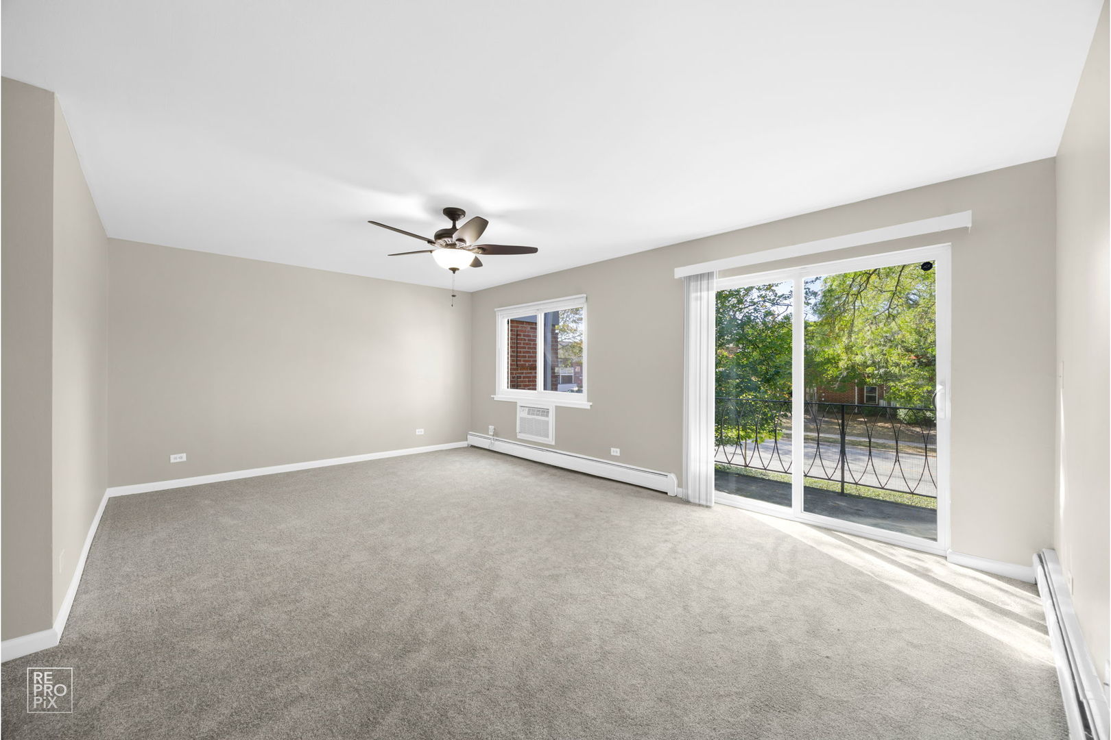 2303 South Goebbert Road, Unit A207 Arlington Heights, IL 60005 - Photo 4 of 15 a view of a livingroom with a ceiling fan and window