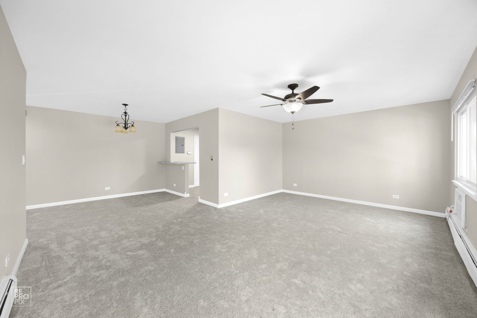 2303 South Goebbert Road, Unit A207 Arlington Heights, IL 60005 - Photo 5 of 15 an empty room with a ceiling fan and a window