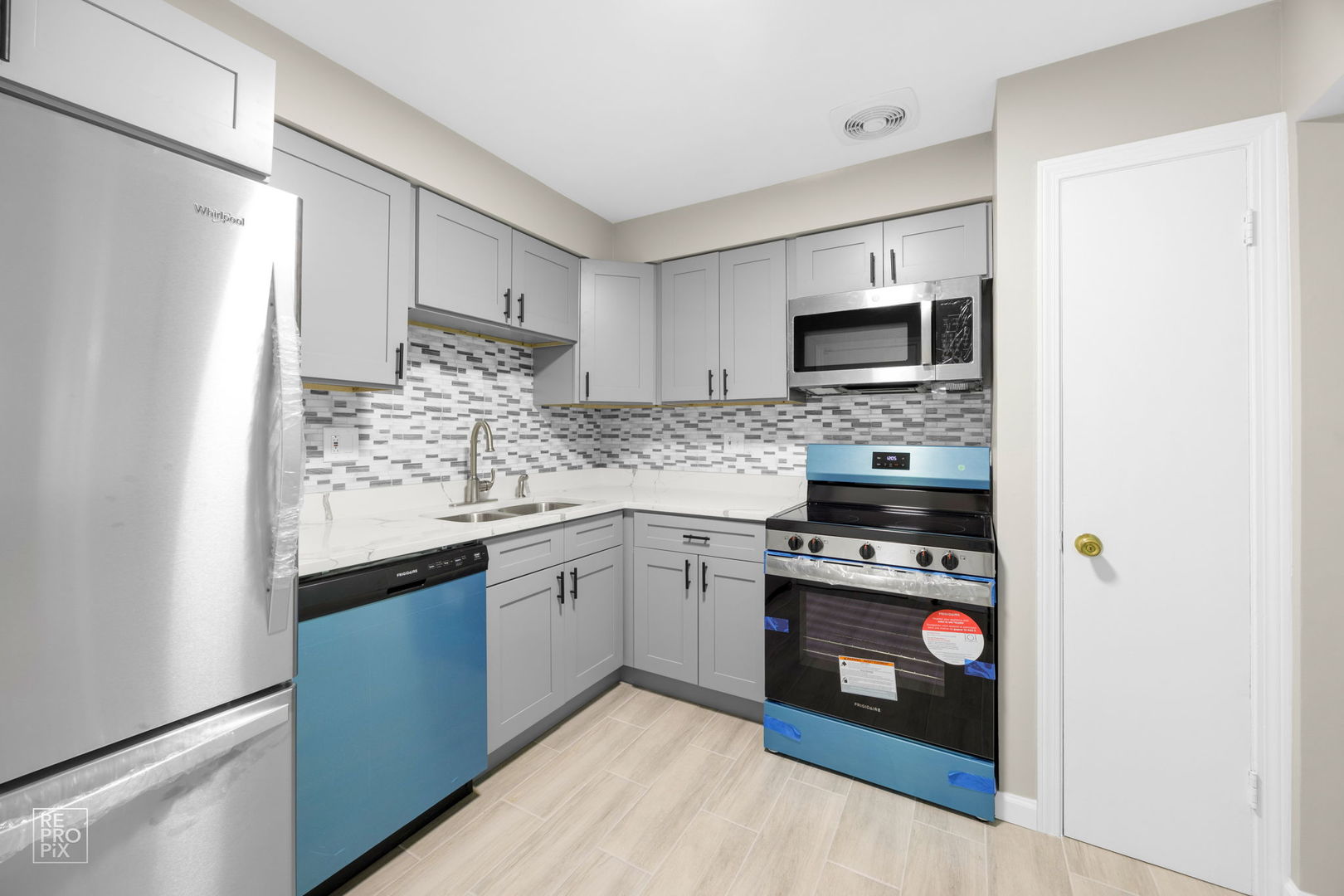 2303 South Goebbert Road, Unit A207 Arlington Heights, IL 60005 - Photo 7 of 15 a kitchen with stainless steel appliances granite countertop a stove sink and microwave