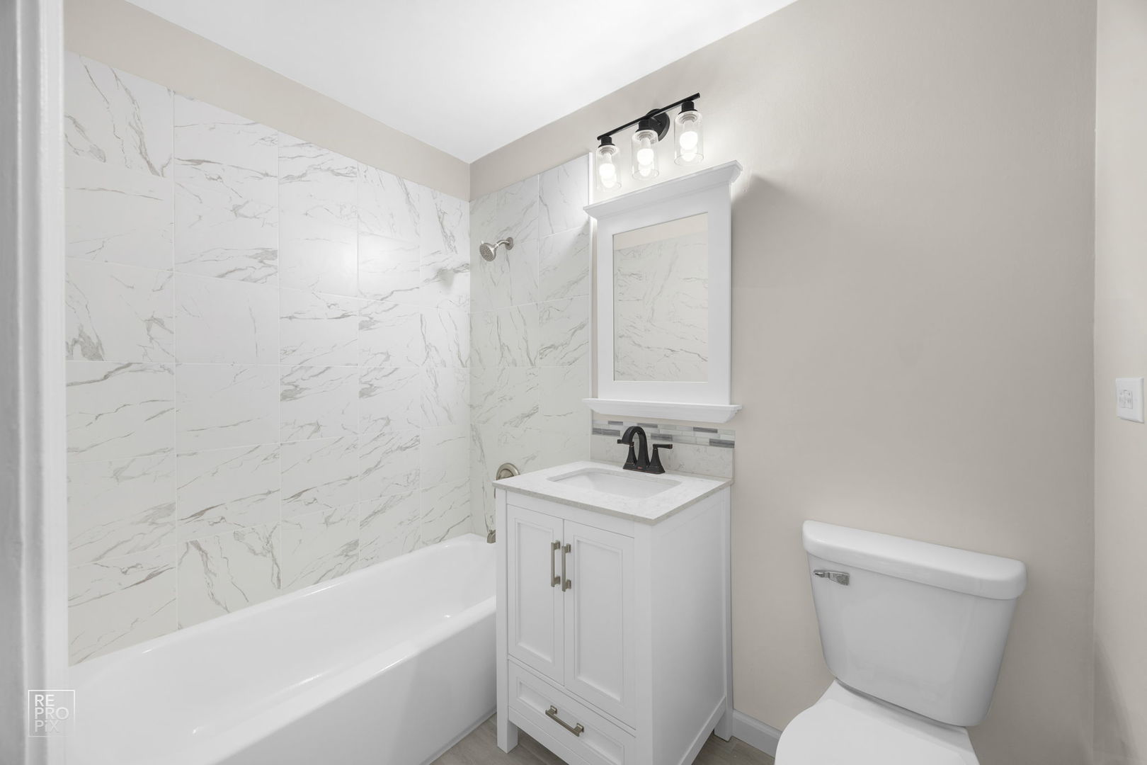 2303 South Goebbert Road, Unit A207 Arlington Heights, IL 60005 - Photo 8 of 15 a bathroom with a sink toilet and bathtub
