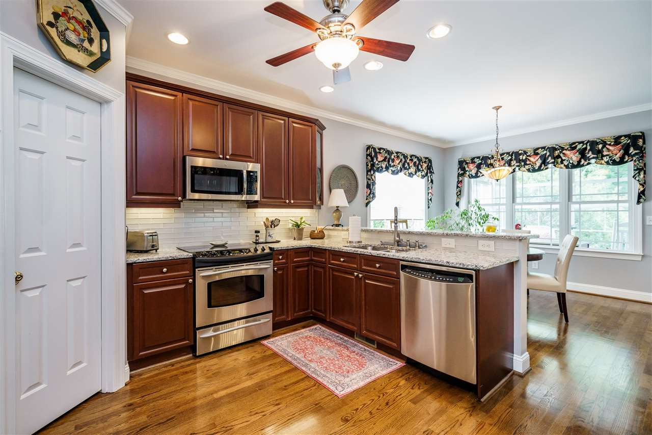 8119 Dreamy Way Raleigh, NC 27613 - Photo 7 of 30 Raised panel cherry, custom cabinets, some with glass fronts with under cabinet lighting. Lots of storage with roll out drawers, walk-in pantry, a lazy Susan cabinet near the double basin sink. Appliances are GE Profile ® Kitchen
