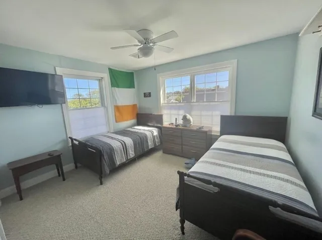 a bedroom with a bed and glass window