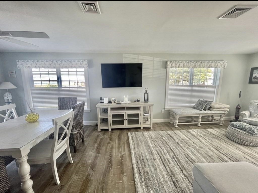 15 10th Avenue Scituate, MA 02066 - Photo 4 of 21 a living room with furniture a flat screen tv and a floor to ceiling window