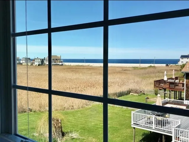 a view of an empty room with large windows