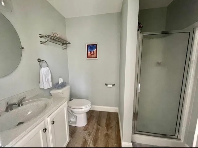 a bathroom with a granite countertop sink toilet and shower