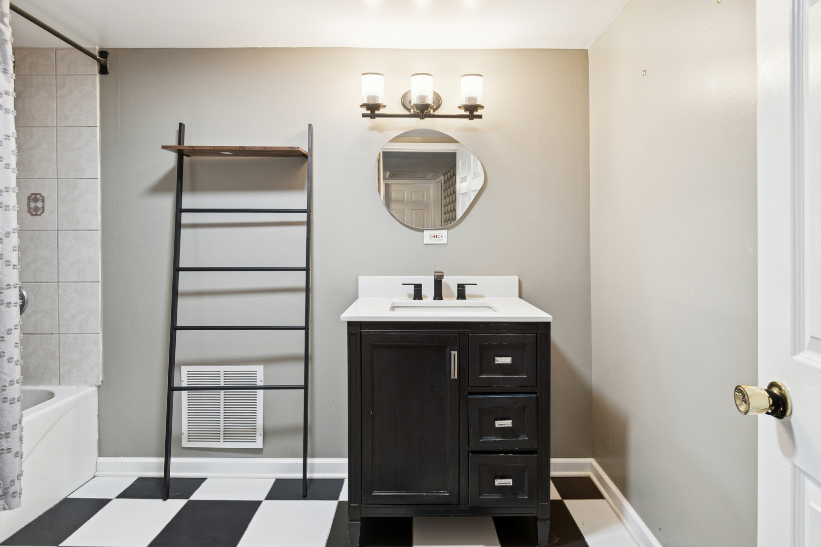 25W361 Doris Avenue Carol Stream, IL 60188 - Photo 11 of 25 a bathroom with a sink a vanity and a mirror